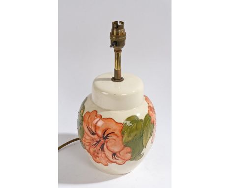 Moorcroft pottery table lamp, of ginger jar form, the cream ground with tube line and painted with lilies, 32.5cm high
