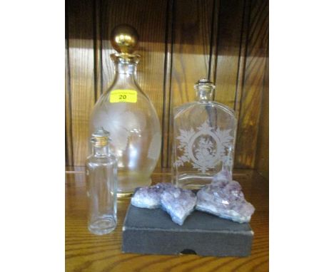 An etched glass decanter, two glass bottles, amethyst rocks, and an Abbey Road money box fashioned as a book 