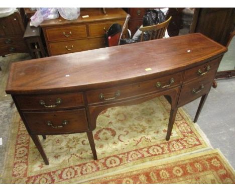 A George III inlaid mahogany, bow fronted sideboard with drawer flanked by a deep drawer and a door, on square legs 