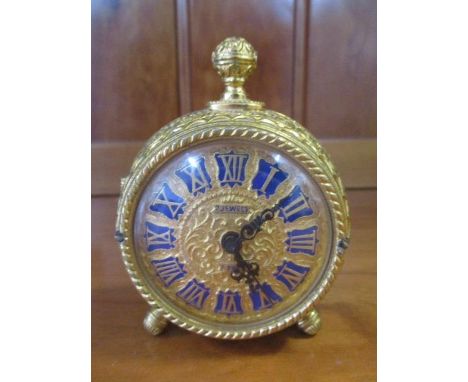 A gilt metal bedside alarm clock 