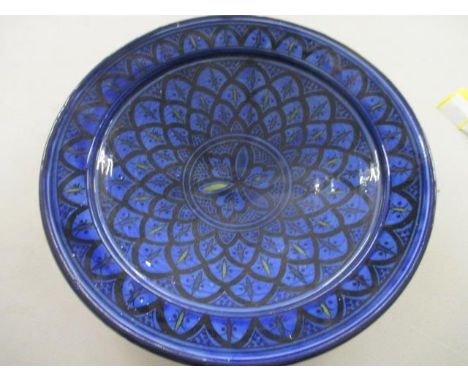 A large ceramic Middle Eastern bowl with a geometric and scroll design 