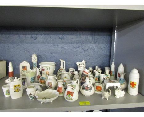 A collection of Goss and other crested china ornaments to include a Goss model of a British 6th Incendiary bomb with City of 