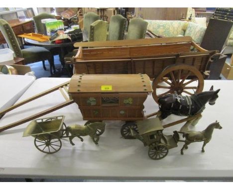 A kitsch musical wooden model of a gypsy caravan with a ceramic horse, a large wooden model of a cart and two brass models of
