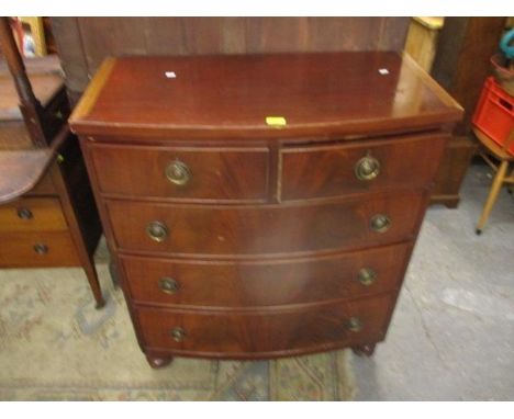 A Victorian mahogany, bow fronted chest of two short and three long drawers, on turned feet 