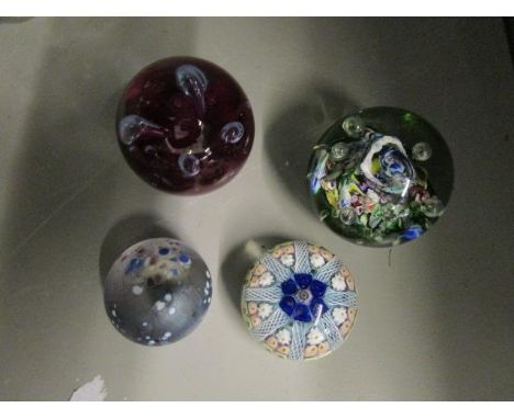 A group of four glass paperweights to include a small Isle of Wight weight, a Strathearn concentric, Millefiori, eight spoke 