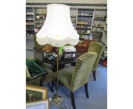 A brass standard lamp with a cream fabric shade 