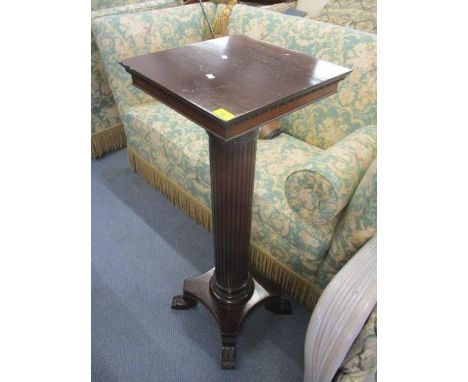 A mahogany torchere with square top, egg and dart moulding with gadroon lower apron, fluted column on quadrofoil base, 41" h 
