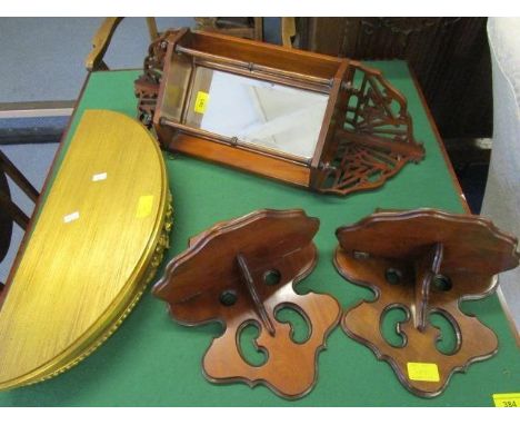 A Victorian mahogany wall hanging corner shelf with bevelled mirrored back, turned finials and open fretwork decoration, a pa