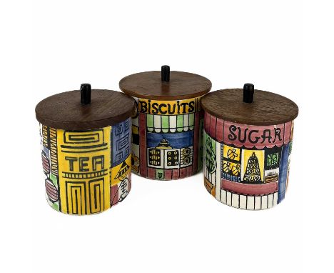 A set of three ceramic canisters with teak covers by ANITA NYLUND for Jie of Sweden.  Biscuits, Sugar and Tea, height 16cm.