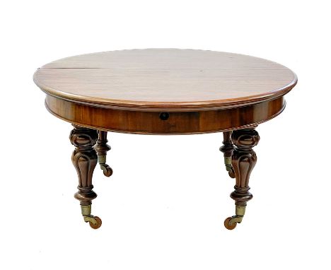 A good early Victorian mahogany oval extending dining table. Fitted with three extra leaves and raised on turned baluster leg