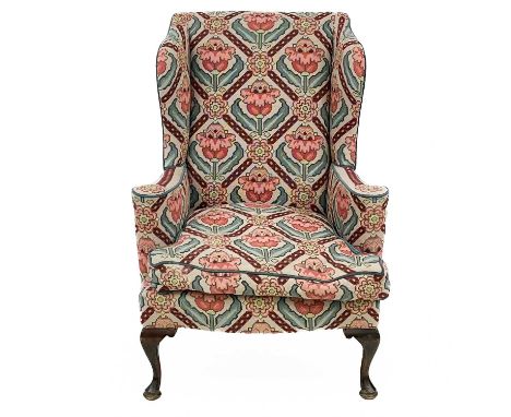 A George III style wing back tapestry armchair. Raised on front cabriole supports and pad feet with square swept back support