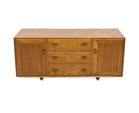 An Ercol Golden Dawn sideboard. Fitted with three central drawers, flanked by cupboards, height 68cm, width 155cm, depth 44cm