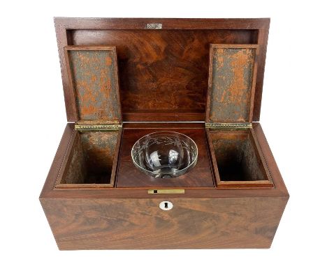 A 19th century flame mahogany tea caddy. The interior in three sections with two lidded removable compartments and a replacem