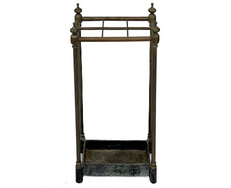 A late Victorian brass and cast iron stick stand. With turned finials and six sections, height 62cm, width 31cm, depth 19cm.