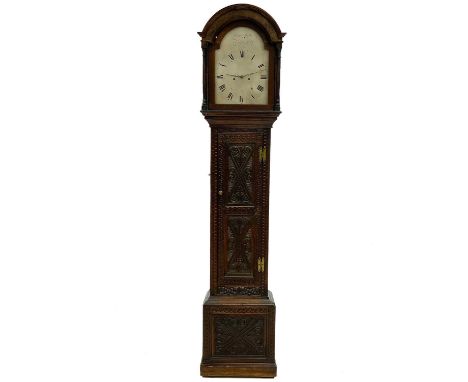 An oak longcase clock The arched silvered dial signed John Miller Bedford, with an eight-day movement and carved case, height