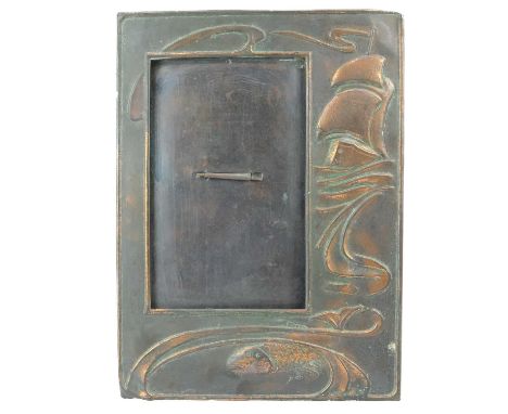 An Arts and Crafts copper picture frame by J & F Pool Hayle    Repousse decoration of a galleon at sea with a fish, height 36