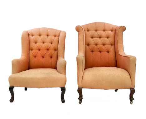 An Edwardian button-back wing armchair. With salmon pink brocade upholstery, on cabriole front legs, height 102cm, width 72cm