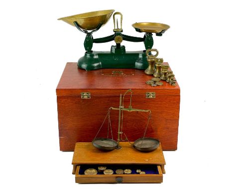 A set of kitchen balance scales. Together with a set of postage scales contained in a Fortnum and mason wooden box. The kitch