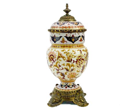 A Zsolnay Pecs gilt metal mounted urn and cover. Circa 1900, painted with flowers and foliage on a cream ground, the gilt met