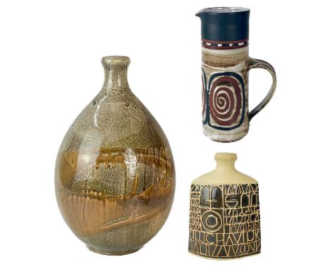 A Briglin studio earthenware jug.  Height 26cm; Together with two Tremaen pottery lamp base's, the largest is 42cm high.The l