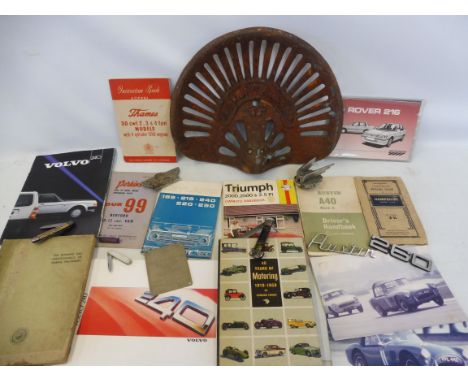 A Doyle tractor seat, a Wolseley car mascot, a Rolls-Royce Ltd serial number plaque and various motoring ephemera.