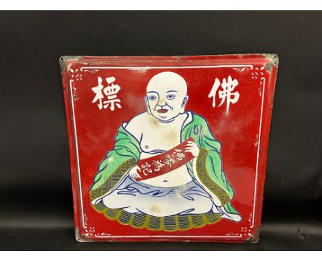 An Oriental enamel sign, decorated with a seated Buddha.