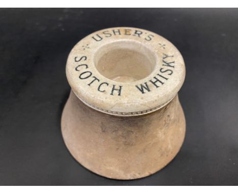 An Usher's Scotch Whisky advertising match striker, 4 1/4" diameter.