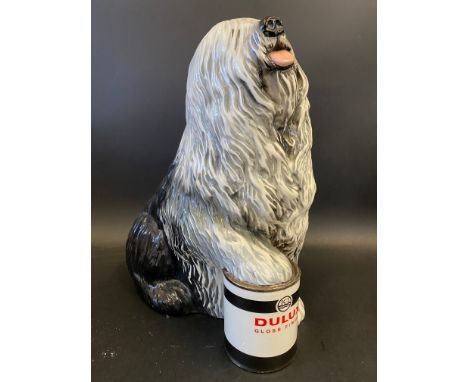 A Beswick Dulux dog, foot on tin model, 12 1/2" h.