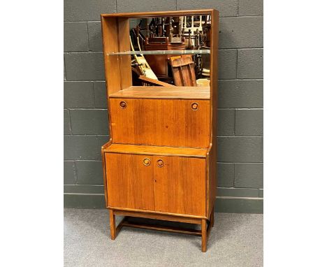 A 20th century teak drinks cabinet with open mirror backed glass shelf over a fall front and pair of cupboard doors162 x 76 x