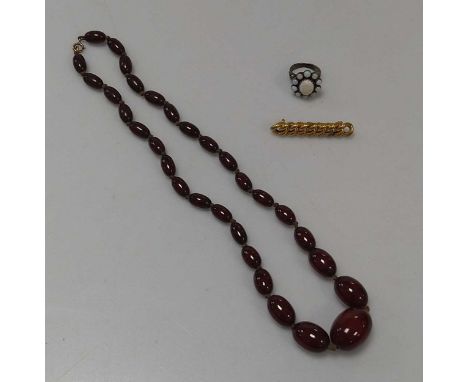 A bakelite bead necklace weight 28.8g, together with a brooch stamped '9CT' weight 4.2g, and an opal ring (3)