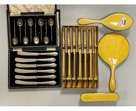 A collection of silverware including 2 cases of silver handled knives, a case of 8 silver and enamel bean end coffee spoons, 