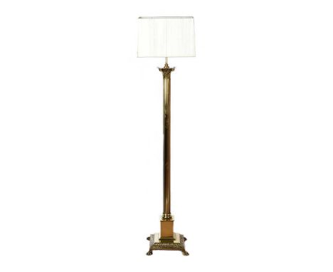 BRASS CORINTHIAN PILLAR STANDARD LAMP. RAISED ON FOUR PAW FEET. COMPLETE WITH SHADE. HEIGHT: 61 INCHES.WIDTH: 11 INCHES.DEPTH