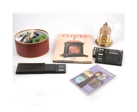 A quantity of watch parts; watchmaker's tools; Tanita Model 1479 digital scales; a Bentima glass-domed clock; and two clock c