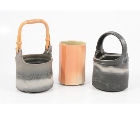 Byron Temple, two stoneware vessels with white and grey fire markings and ash deposits, one with rattan handle, Leach Pottery