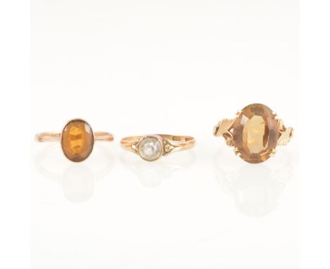 Three gem set rings, an oval mixed cut golden quartz 16x11.8mm, four double claw set in a 9 carat yellow gold mount, leaf des