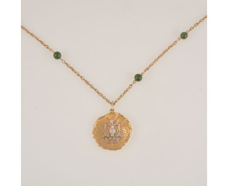 A 9 carat yellow and white gold Libra zodiac pendant, the white gold scales on yellow gold molten finish disc 35mm diameter, 