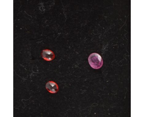 Gem Collector - A loose, faceted Thai ruby, oval fancy cut, 0.200 carats, 5mm x 3.75mm, treated; and two loose, faceted Songe