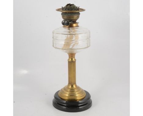 An oil lamp, fluted brass column, glass reservoir, composition base, 43cm.