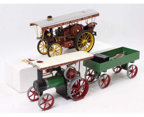A Mamod steam traction engine with canopy complete with burner and scuttle, and accompanying trailer together with a Bandai k