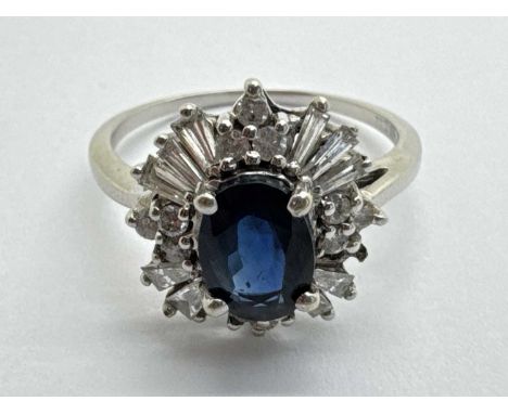 A Sapphire and Diamond Abstract Cluster Ring, the oval centre stone, four claw set within abstract tapered baguette and round