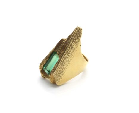 A Large Abstract Style Single Stone Ring, the elongated stone within abstract bark textured surround, between wide tapering s
