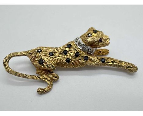 A 9ct Gold Stone Set Leopard Brooch, of naturalistic design, the inset highlights within allover textured surround, with whit