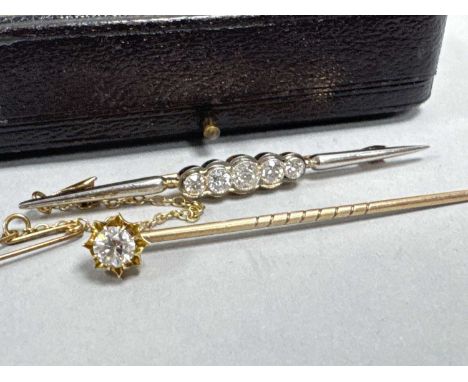 A Five Stone Diamond Bar Brooch, the round cut stones graduated millegrain set betwen scalloped style surround, between taper