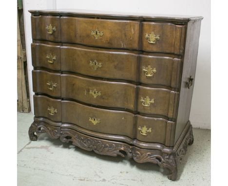 COMMODE, 18th century North German oak with four serpentine drawers and brass side handles on low foliate carved stand, 109cm