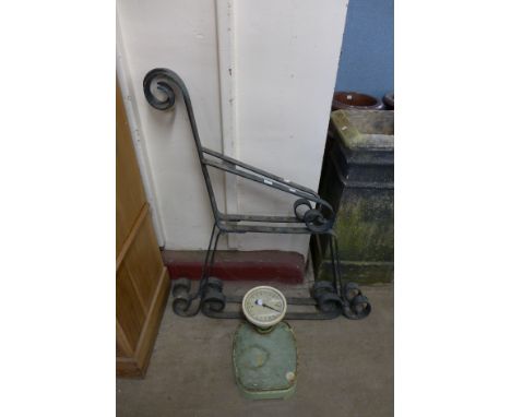 A pair of wrought iron bench ends and a set of scales