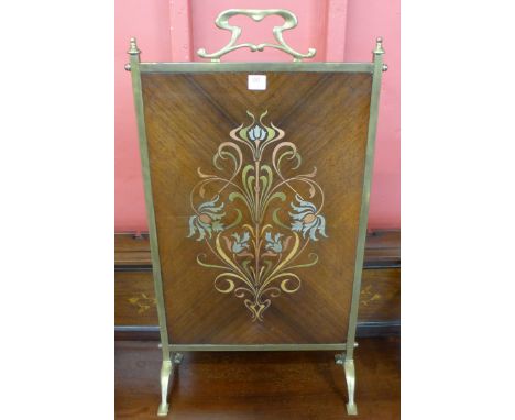 An Art Nouveau brass and inlaid mahogany fire screen