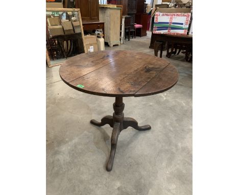 A 19th century oak snap-top tripod table on cabriole support. 32' diam