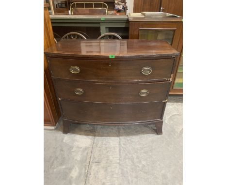 A George III mahogany bowfronted chest of three long drawers on splayed bracket feet. 42' wide