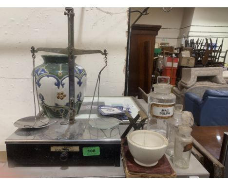 A set of chemist's scales with glass jars, pestle etc.
