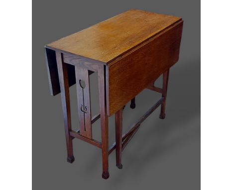 An Arts and Crafts oak gate leg table with Tulip carved pierced end supports, 76cms wide